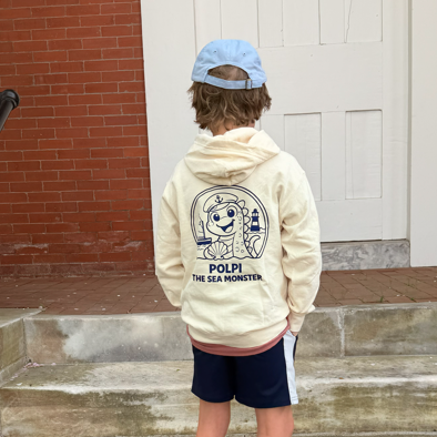 Child wearing a hoodie with a character design and text, standing on steps.