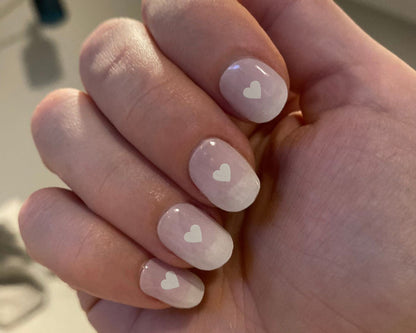 Love Notes nail art bundle look, an ombre pink mani with white heart details