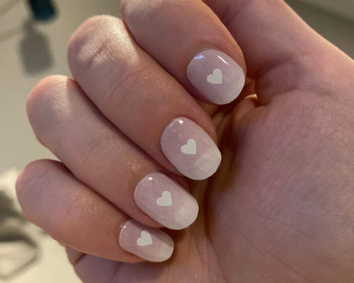 Love Notes nail art bundle look, an ombre pink mani with white heart details