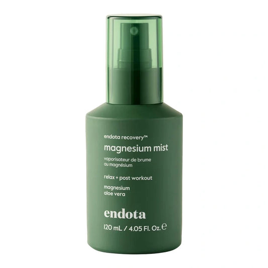 Green bottle of endota magnesium mist on a white background.