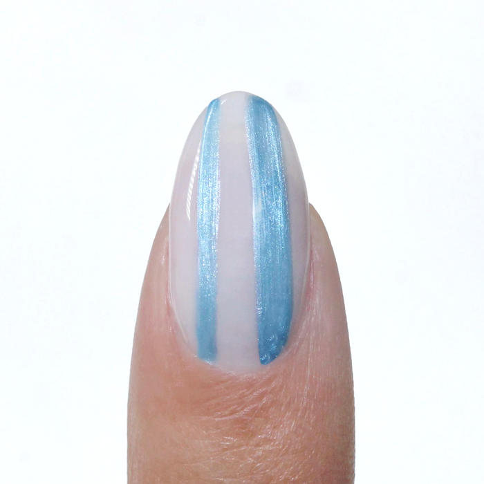 Metallic Muse liner used for a metallic blue vertical stripe on a sheer nude nail