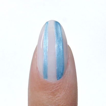 Metallic Muse liner used for a metallic blue vertical stripe on a sheer nude nail