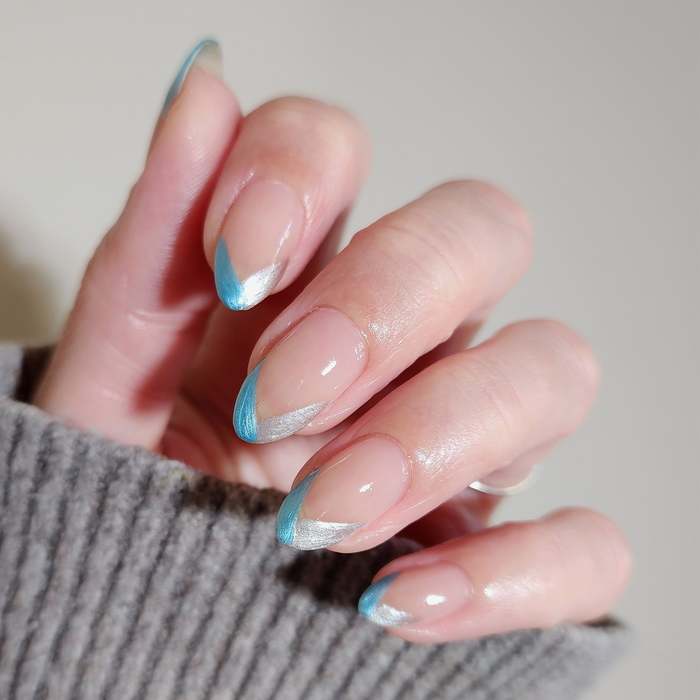 Metallic Muse liner used for thin blue French tips on a light skin tone