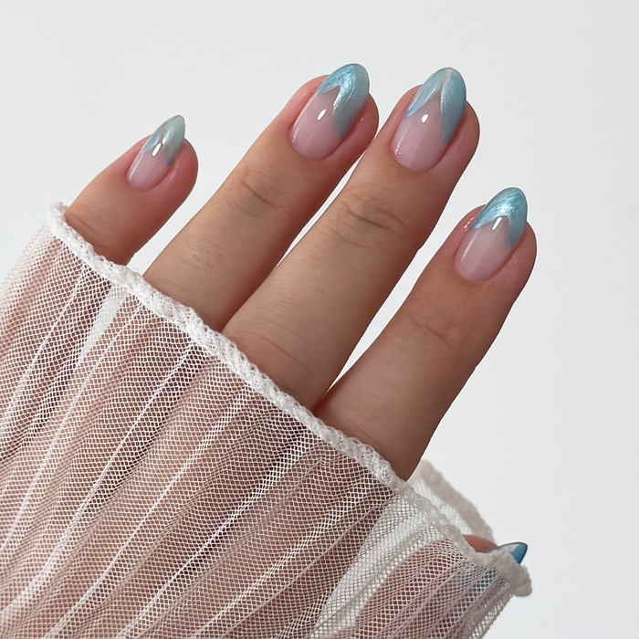 Metallic Muse liner used for blue French tip nail art on a light skin tone with a sheer sleeve