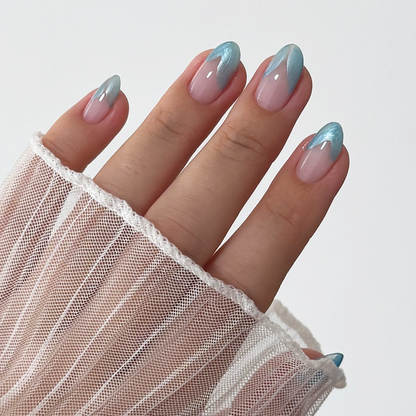 Metallic Muse liner used for blue French tip nail art on a light skin tone with a sheer sleeve