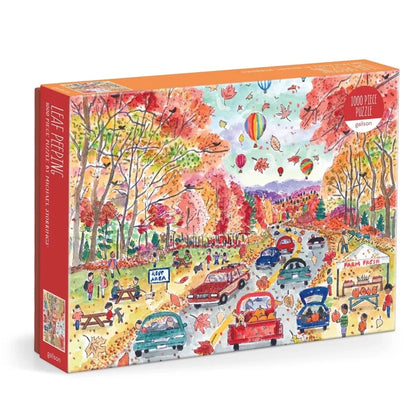 Enjoy the beauty of the season with Galison’s Michael Storrings Leaf Peeping 1,000 Piece Jigsaw Puzzle, capturing a lively autumn scene filled with cars, people, colorful fall trees perfect for leaf peeping, hot air balloons, and a cozy roadside farm stand.