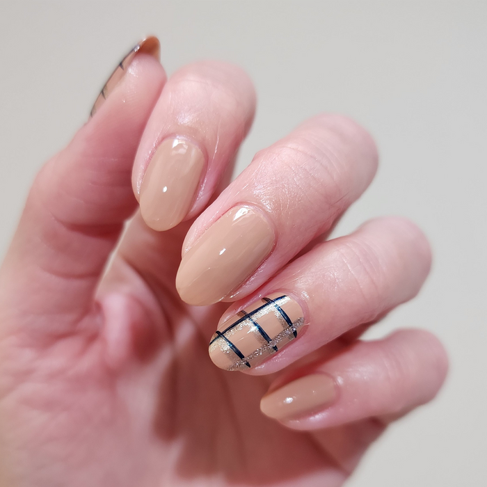 Midnight Rising liner used for a thin plaid accent nail on a nude manicure