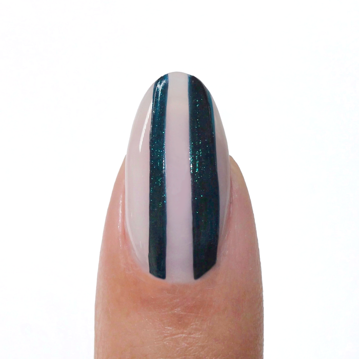 Midnight Rising liner used for dark navy vertical stripes on a sheer nude nail