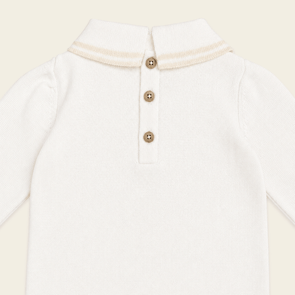 close up back view of milan dove white cable knit baby jumpsuit made of organic cotton