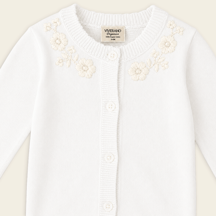 detail  of dove white floral embroidered knit baby jumpsuit made with organic cotton