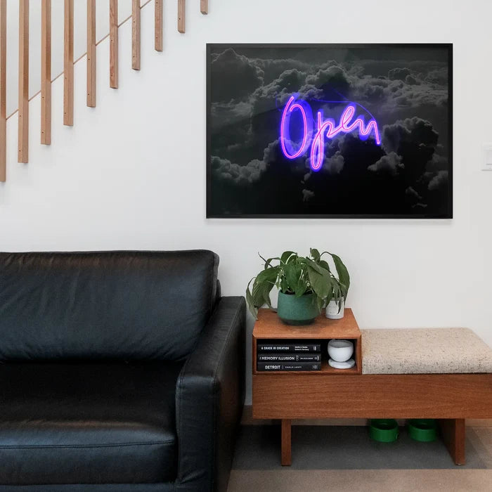 Purple neon script sign reading Open, displayed as a framed art print over a moody dark cloud background.
