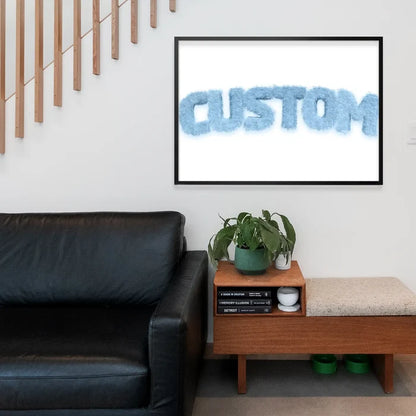 Framed pastel blue fur-style "CUSTOM" name print above a black sofa and wooden bench.