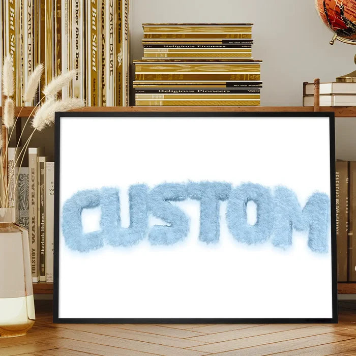 Framed pastel blue fur-style "CUSTOM" name print on a white background, displayed on a wooden shelf.