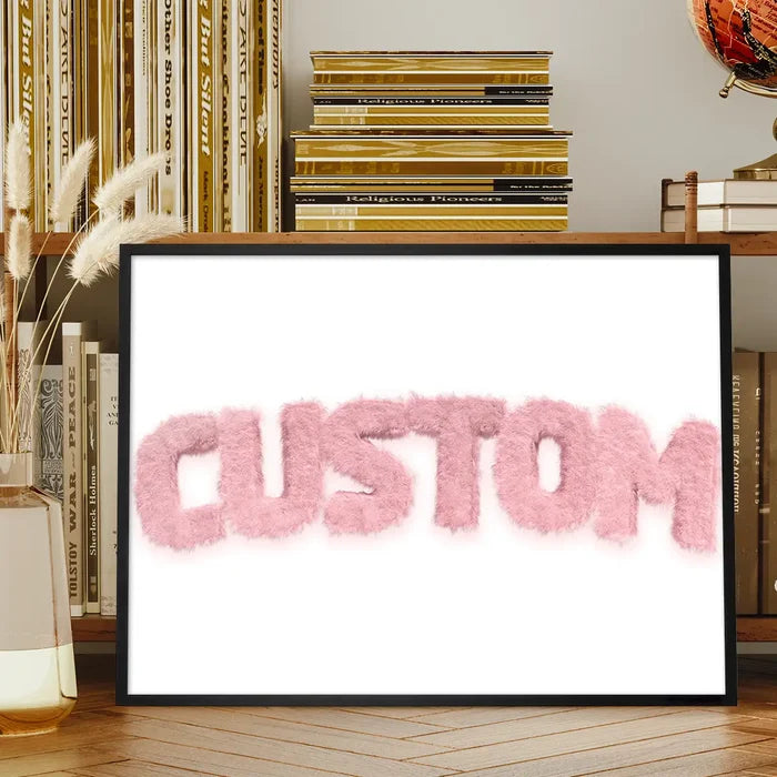 Framed pastel pink fur-style "CUSTOM" name print on white, displayed on a wooden shelf.