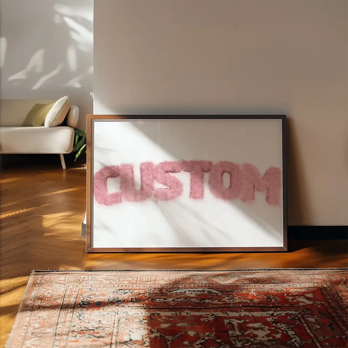 Framed pastel pink fur-style "CUSTOM" name print on a white background, leaning against a wall.