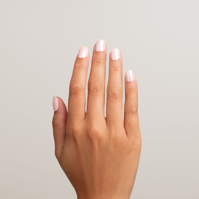 Hand with light pink nail polish