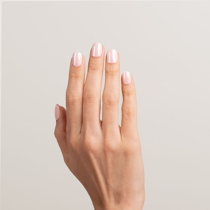 Hand with glossy pink nail polish