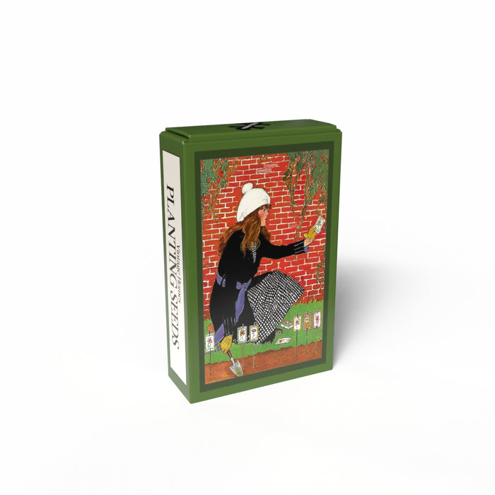 The Penny Puzzle Planting Seeds | 99 Piece Jigsaw Puzzle comes in a green vintage-style rectangular box featuring a gardening woman illustration and "PLANTING SEEDS" text, with a charming 99-piece mini puzzle inside.