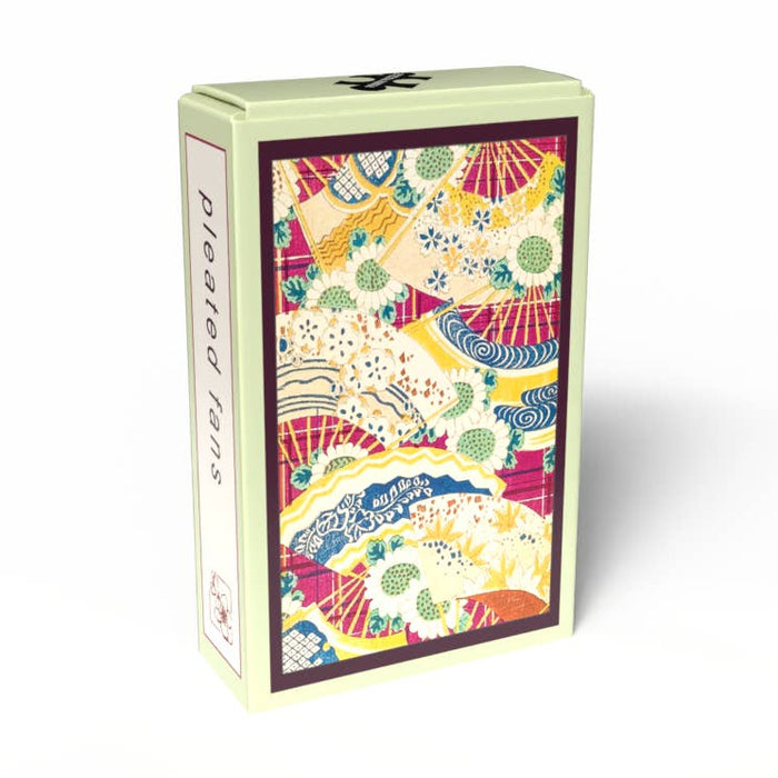A rectangular box from Penny Puzzle, decorated with a vibrant pattern of pleated fans and flowers, reminiscent of vintage Japanese puzzles, and labeled "Pleated Fans | 99 Piece Jigsaw Puzzle" on the side.