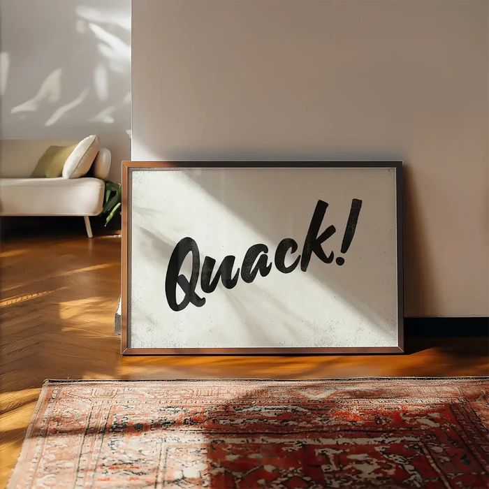 Minimalist "Quack!" animal sound print with black brush script on a light background, in a wooden frame.