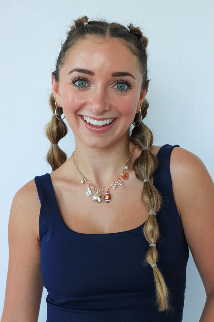 Woman with braided hair wearing a blue top against a light background