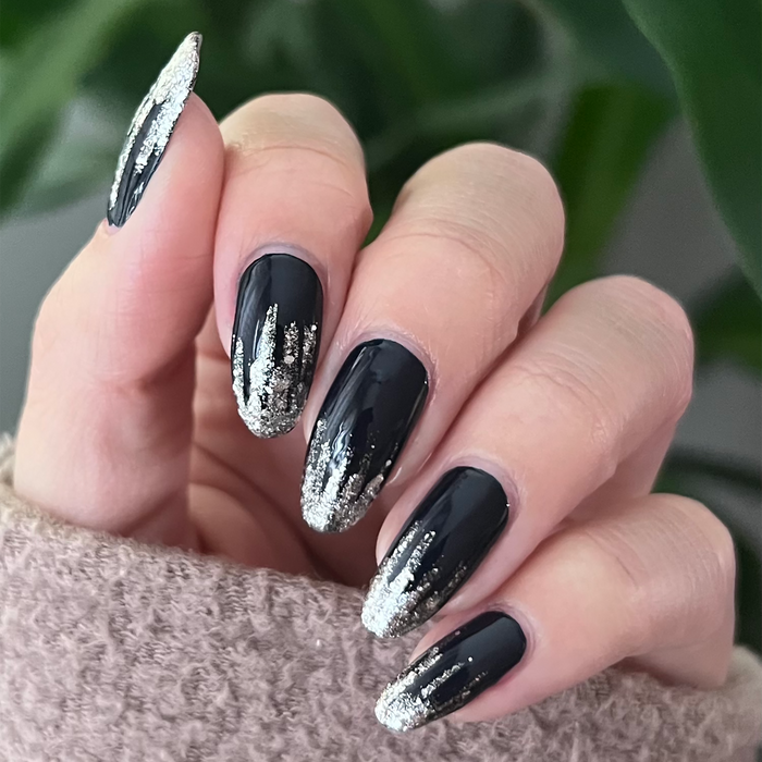 Silverpoint silver glitter liner used for brushstroke accents on a black manicure
