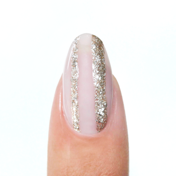 Silverpoint liner used for a silver glitter vertical stripe on a sheer nude nail