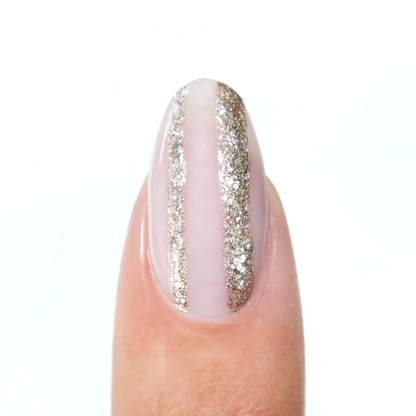 Silverpoint liner used for a silver glitter vertical stripe on a sheer nude nail