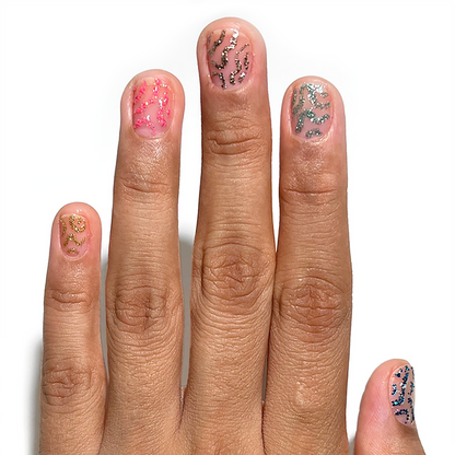Silverpoint and glitter liners used for abstract accent nail art on a medium skin tone