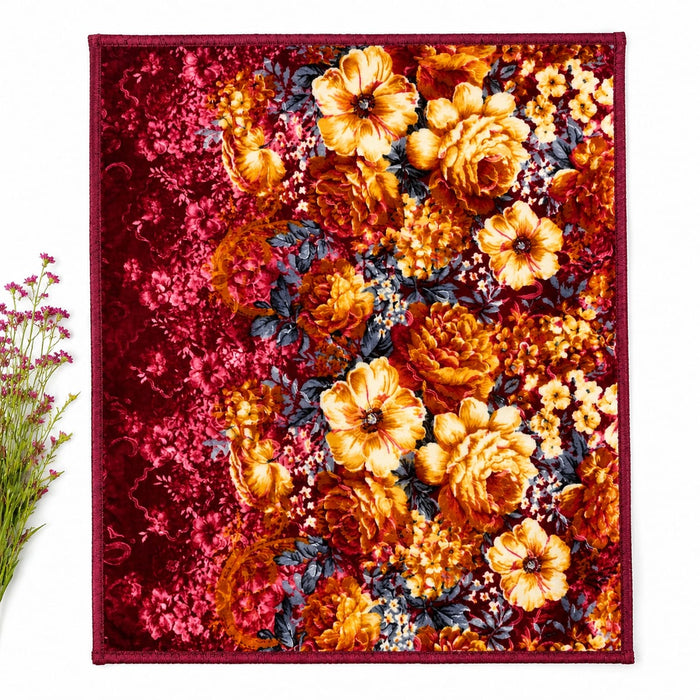 A square textile product, likely a scarf or small blanket, featuring a dense floral pattern with prominent orange and yellow flowers, deep red background areas, and dark blue-gray leaves. The textile is laid flat against a white background with a small de