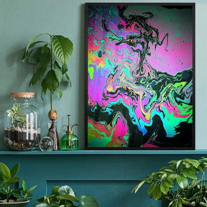 Vibrant Slick 1 abstract oil slick print on archival paper, framed in black, on a teal shelf with plants.