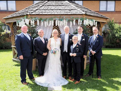 Groomsmen wearing the Snowdrop Ivory Wedding Tie - Perfect Bridal Accessory, styled with navy suits for a coordinated wedding party look.