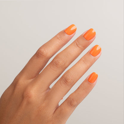 Hand with bright orange nail polish