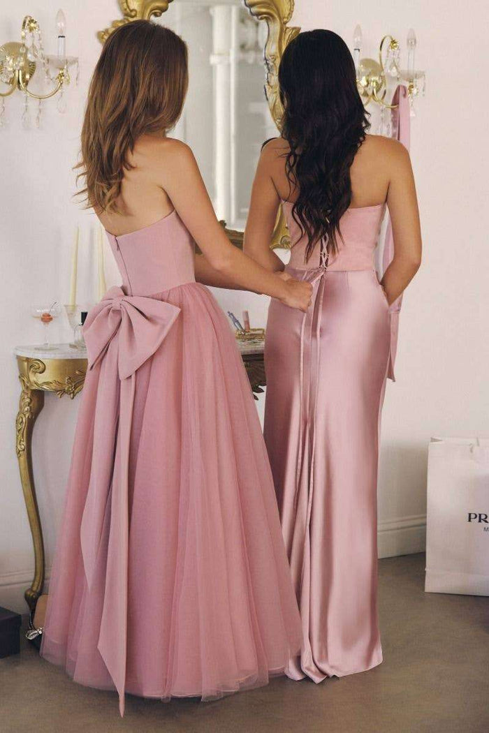 Back view of T712 Light Pink Strapless Tulle A-Line Dress - Light Pink with oversized bow and layered tulle skirt, paired with satin gown.