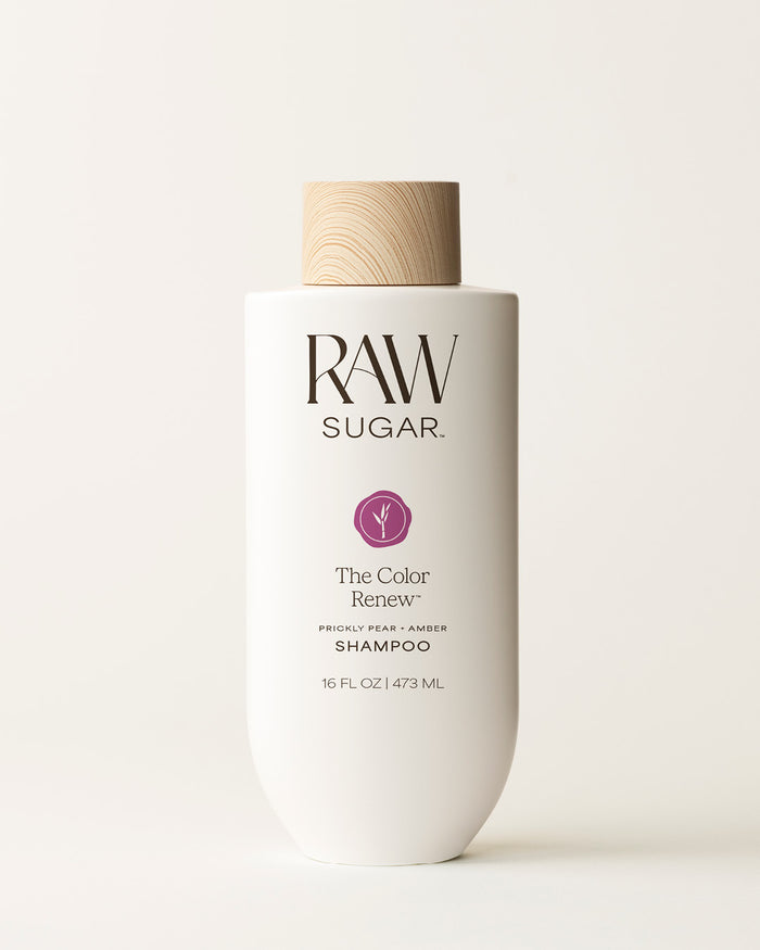 Bottle of Raw Sugar Color Renew Shampoo on a cream background, designed to help color-treated hair with clean ingredients.