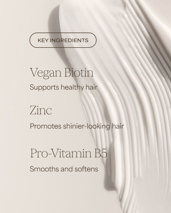 Key ingredients for hair care product with vegan biotin, zinc, and pro-vitamin B5 on a light background.