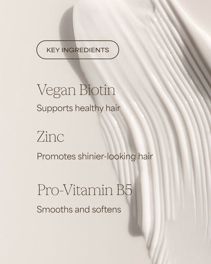 Key ingredients for hair care product with vegan biotin, zinc, and pro-vitamin B5 on a light background.
