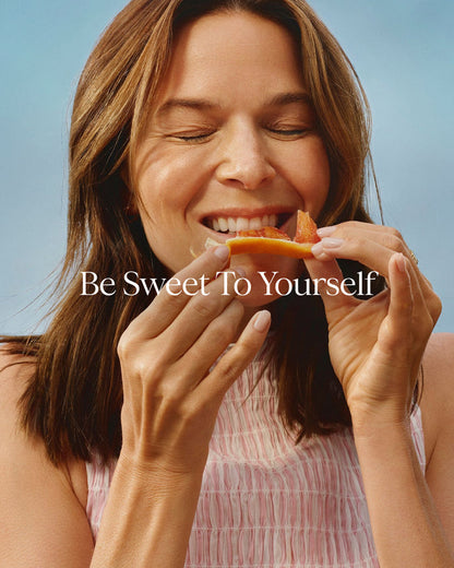 Woman eating a slice of watermelon with 'Be Sweet To Yourself' text overlay.
