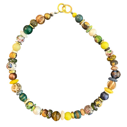 A multicolor beaded necklace with a gold clasp, featuring a mix of round and textured glass beads in yellow, green, blue, brown, and white, displayed on a solid white background.