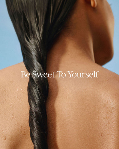 Person with a braided hairstyle against a clear blue sky, with 'Be Sweet To Yourself' text.