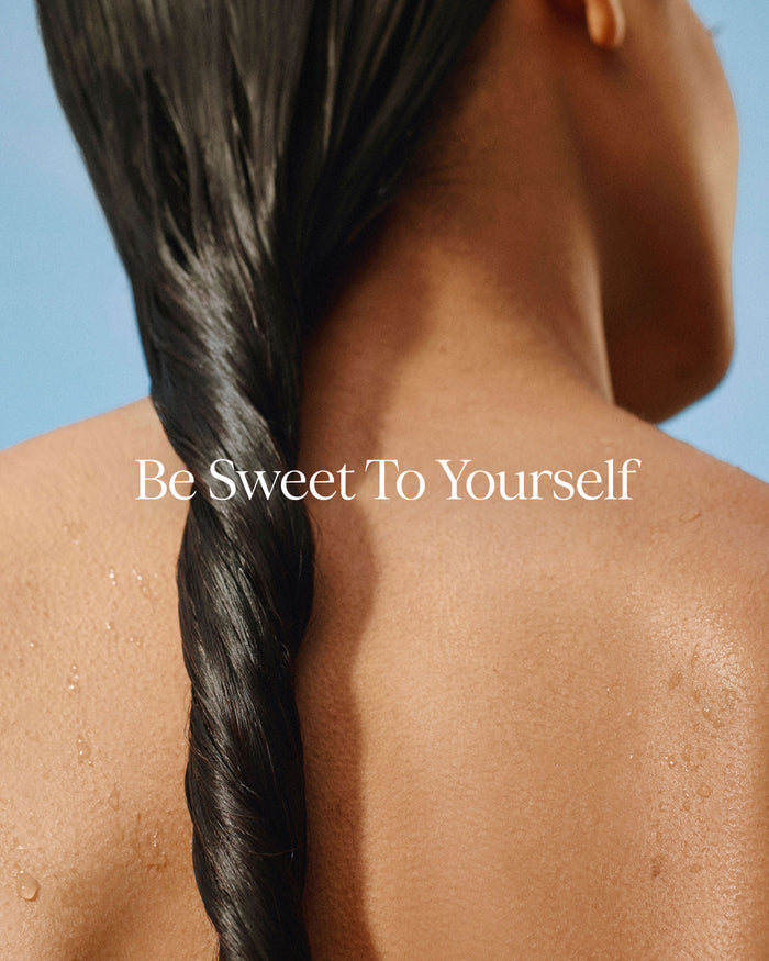 Person with a braided hairstyle against a clear blue sky, with 'Be Sweet To Yourself' text.
