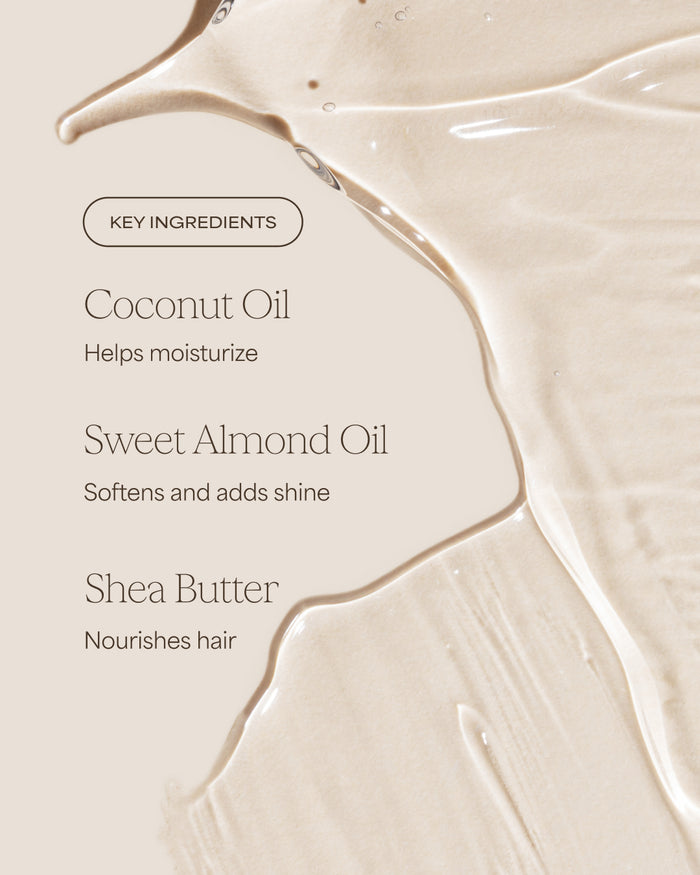 Close-up of a smooth, beige surface with text listing key ingredients for a hair product.
