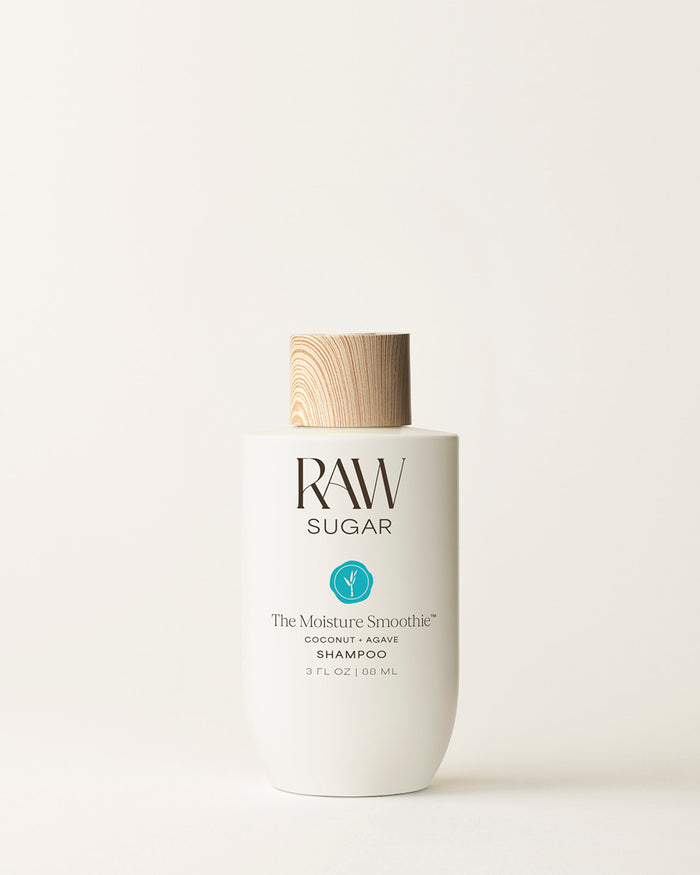 Travel Bottle of Raw Sugar Moisturizing Shampoo on a cream background, designed to help moisturize hair with clean ingredients.
