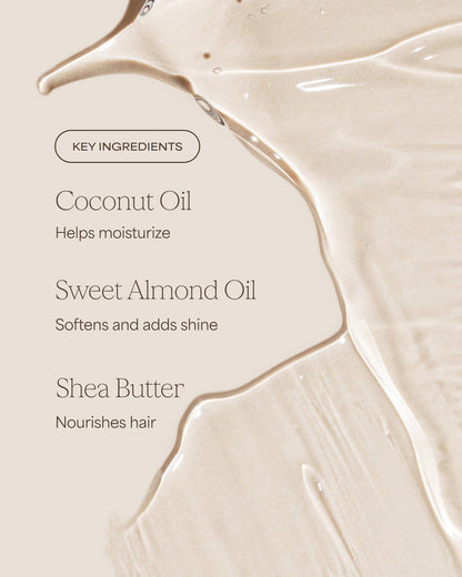 Close-up of a smooth, beige surface with text detailing key ingredients of a hair care product.