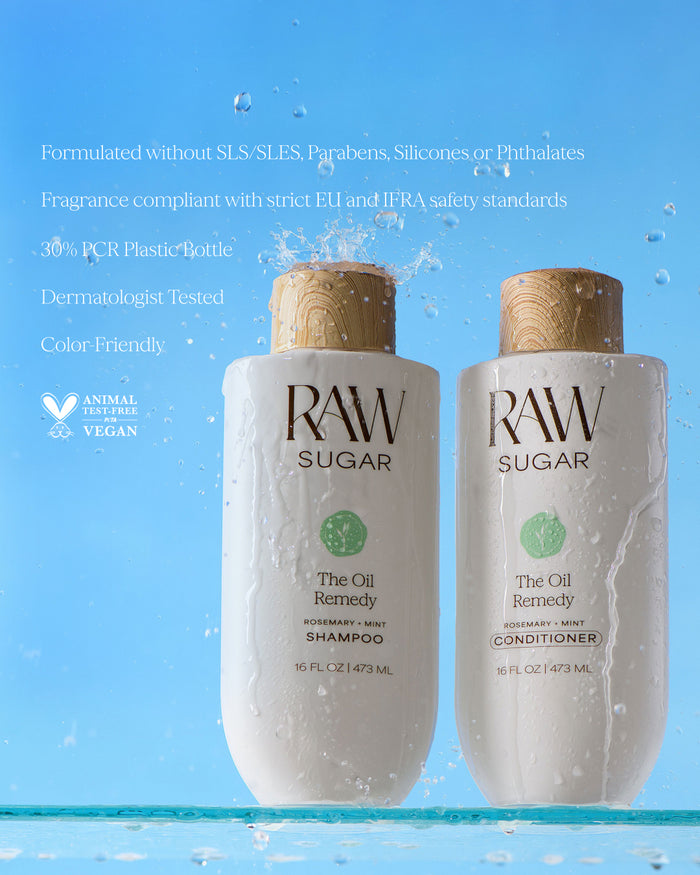 Two bottles of RAW Sugar shampoo and conditioner on a blue background with water droplets.
