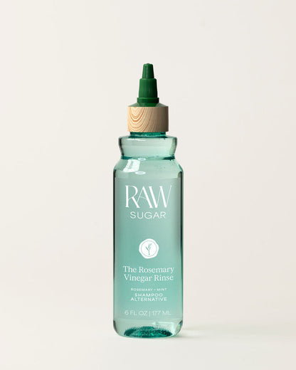 Bottle of Raw Sugar Rosemary  Vinegar Shampoo on a cream background, designed to help refresh hair with clean ingredients.