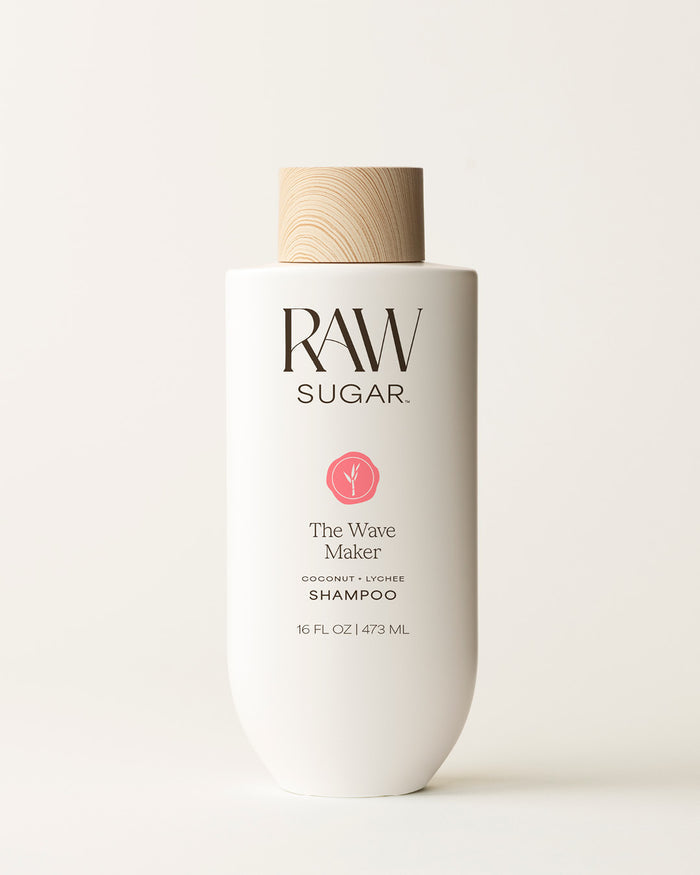 Bottle of Raw Sugar Wave Maker Shampoo on a cream background, designed to help cleanse hair with clean ingredients.