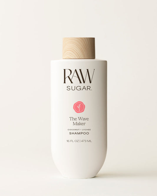 Bottle of Raw Sugar Wave Maker Shampoo on a cream background, designed to help cleanse hair with clean ingredients.