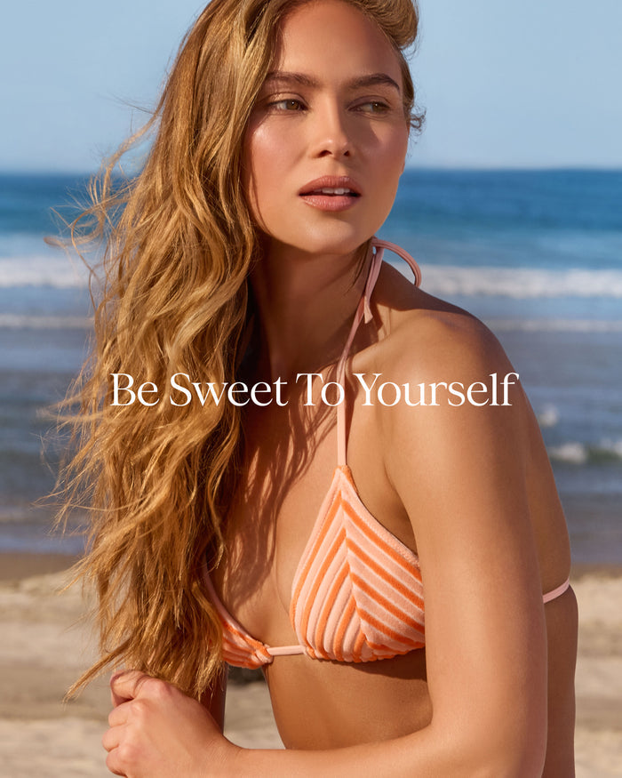 Woman in a striped bikini on a beach with 'Be Sweet To Yourself' text overlay.