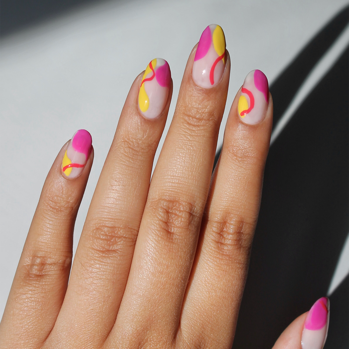 Ultra Violet and neon liners used for abstract swoosh nail art on a light skin tone
